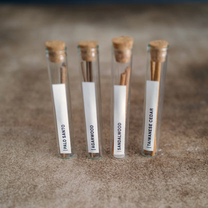 Incense sticks scent samples in four labeled glass vials